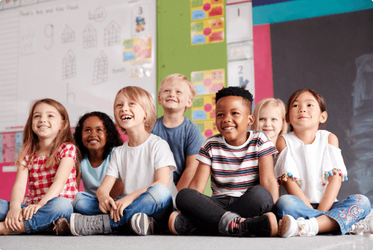 kids sitting and smiling